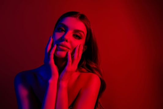 Woman using a red light therapy mask for skin rejuvenation
